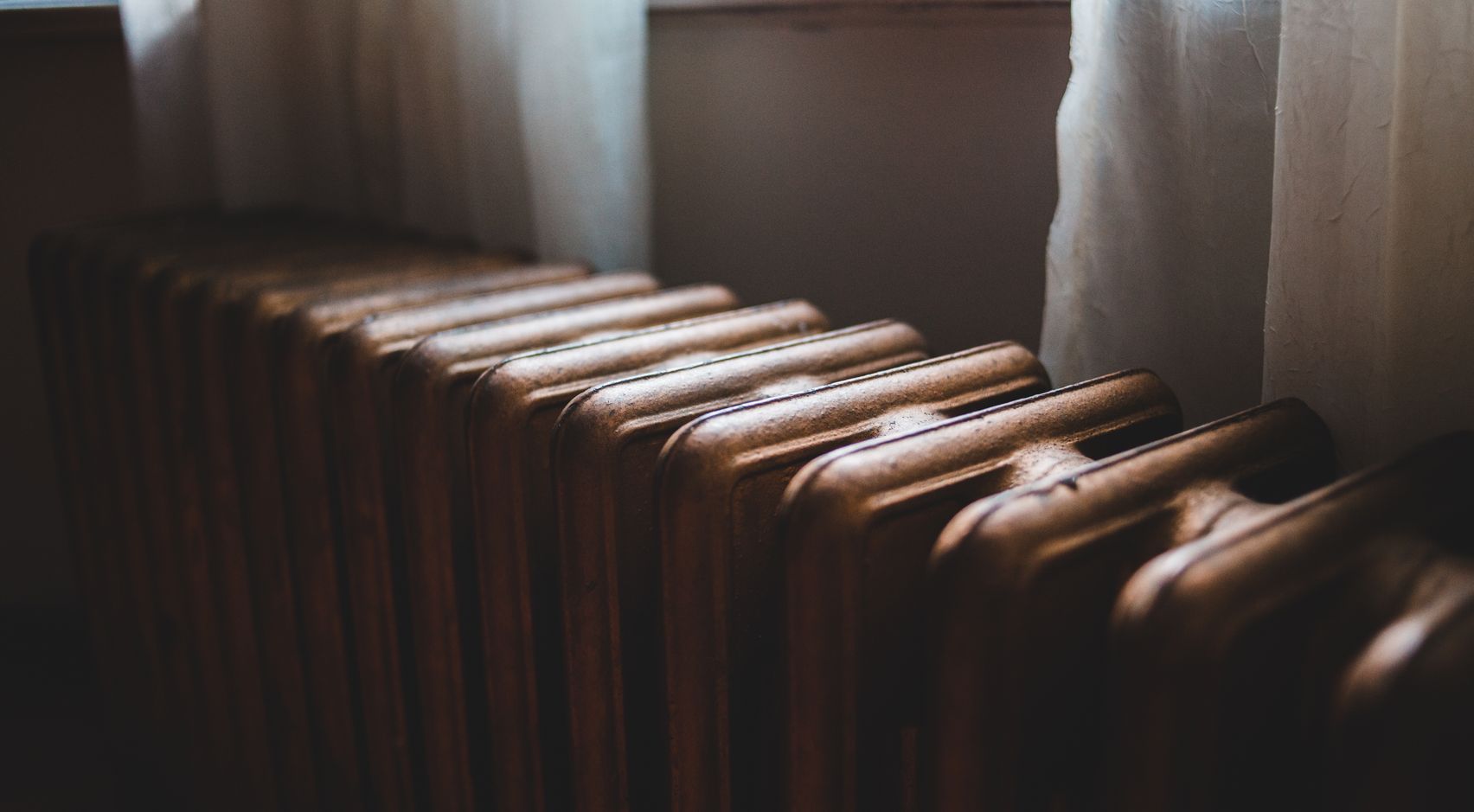 Traditional radiator beside a window
